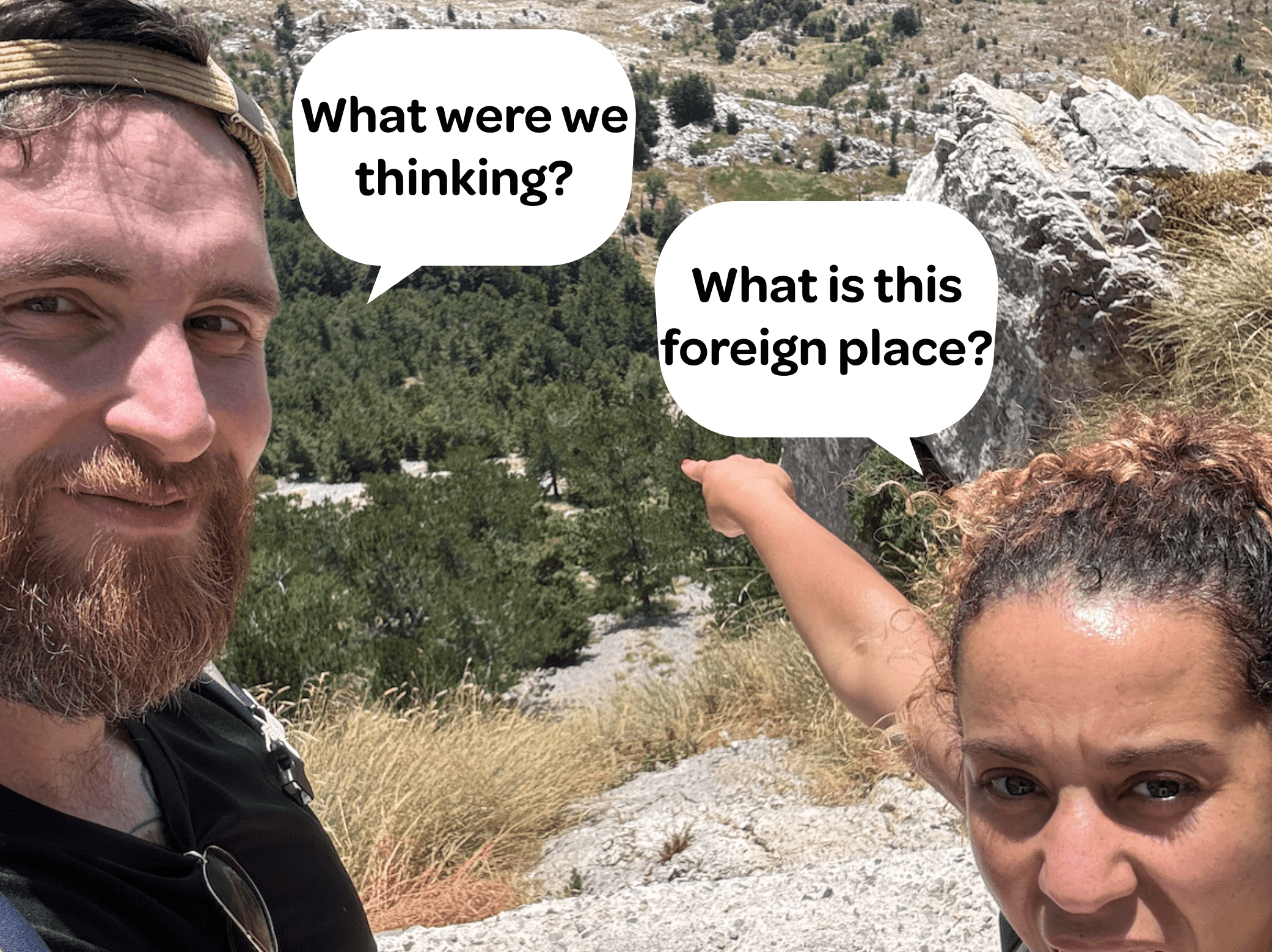 Parents on a hike in rocky terrain, looking slightly confused and overwhelmed