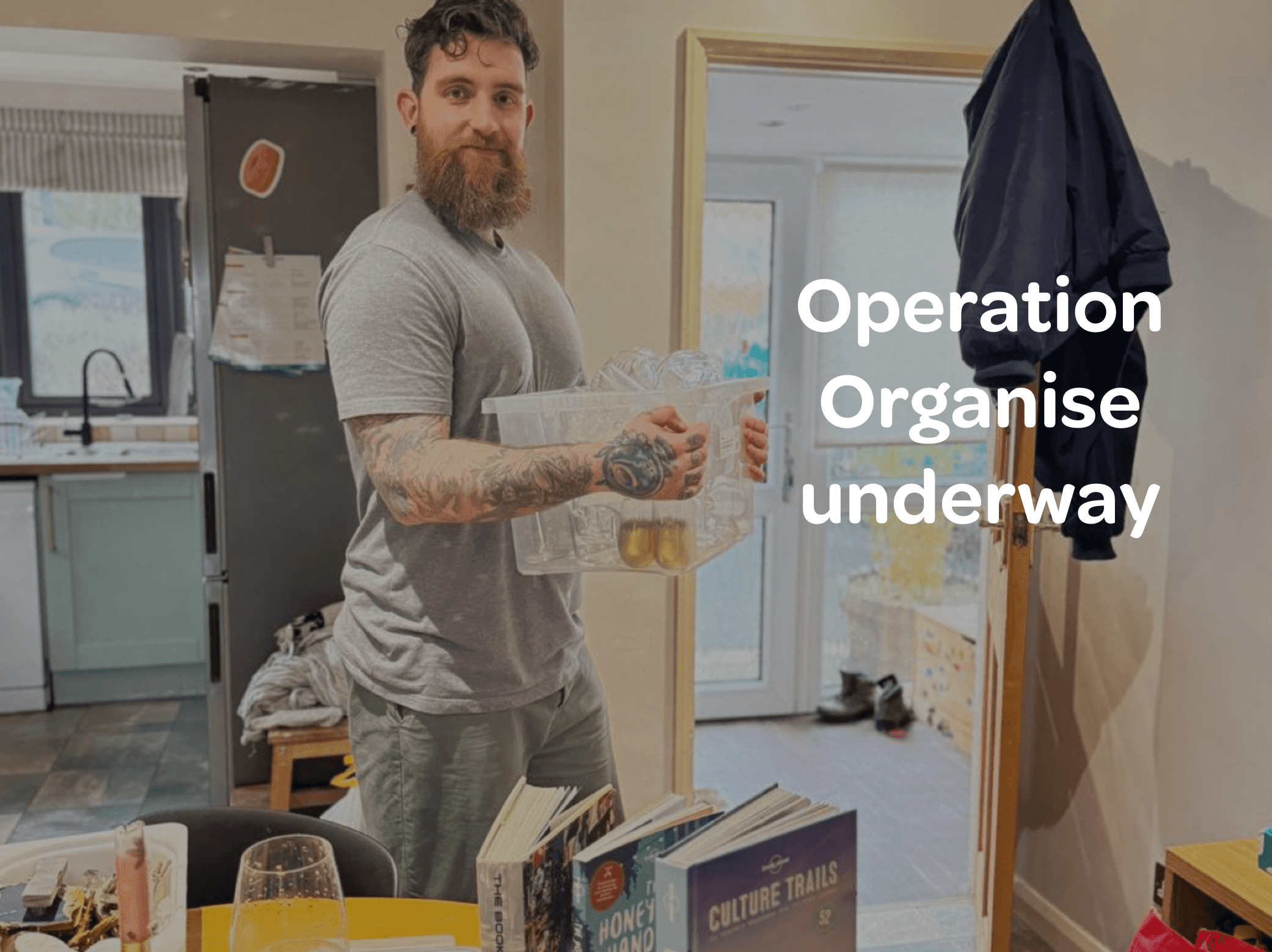 Dad in home kitchen holding plastic tubs while packing and decluttering before travel