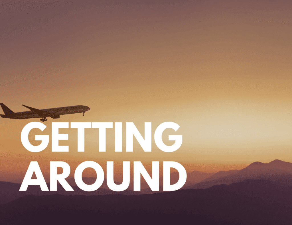 Airplane flying at sunset over mountains — symbolizing transportation options and travel costs in Panama.
