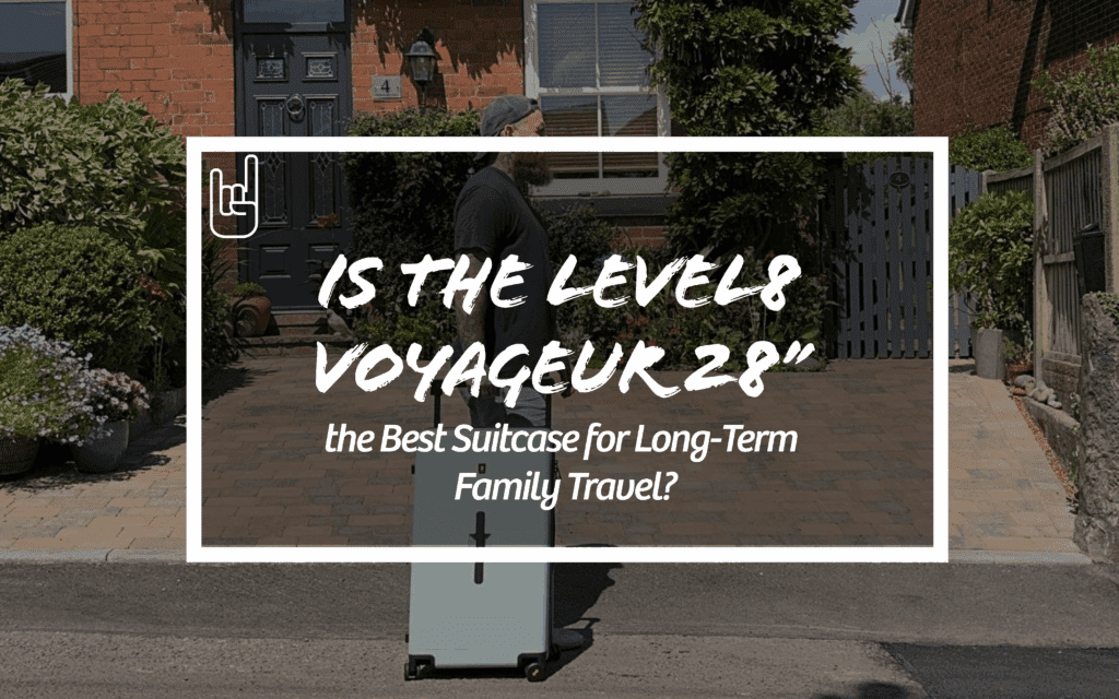 Man walking with Level8 Voyageur 28" suitcase in front of house – is it the best suitcase for long-term family travel?